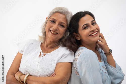 A YOUNG WOMAN AND MOTHER SMILING AND POSING IN FRONT OF CAMERA photo