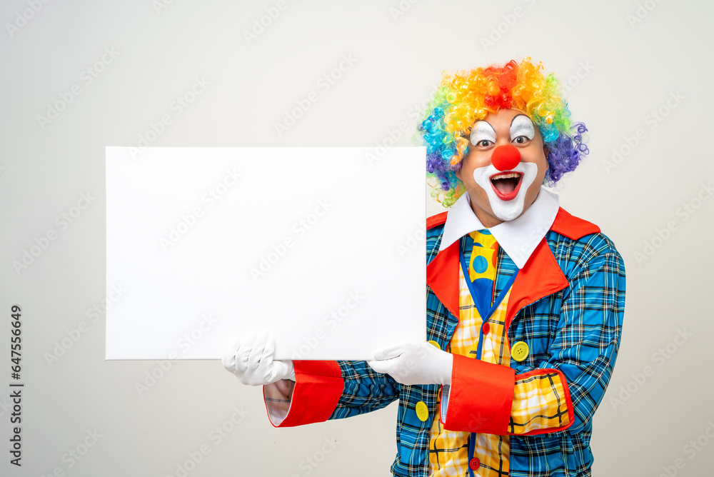 Mr Clown. Portrait of Funny face Clown man in colorful uniform standing holding copy space. Happy expression male bozo in various pose with frame mockup blank space on isolated background. Mr Clown. Portrait of Funny face Clown man in colorful uniform standing holding copy space. Happy expression male bozo in various pose with frame mockup blank space on isolated background.