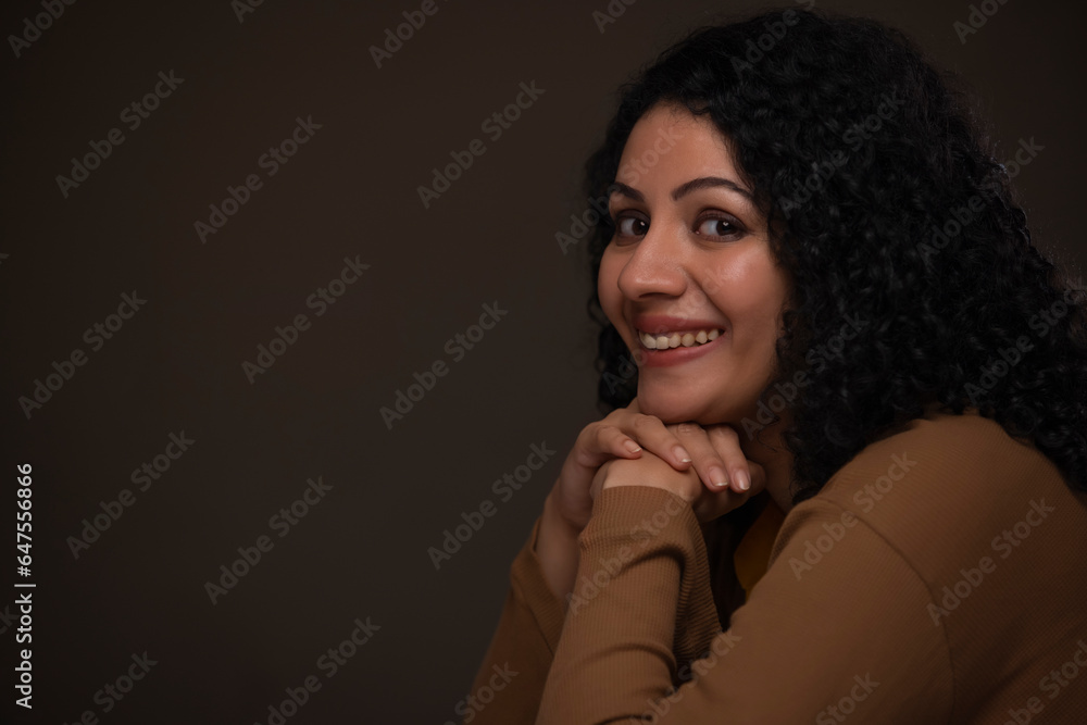 Portrait of an adult woman with her chin resting on both hands looking at camera with cross-eyed Portrait of an adult woman with her chin resting on both hands looking at camera with cross-eyed