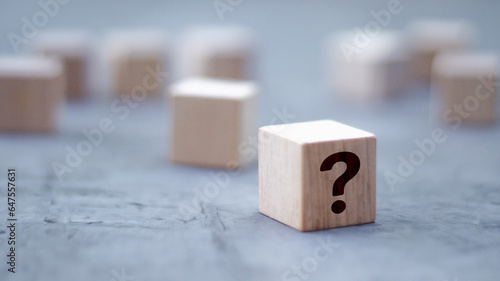 wooden block in question mark mean what on cement table black background wood cube business teamwork concept