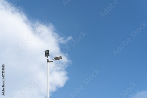 LED street lamps with energy-saving technology, cloud on sky background. Street lamp and post and clear sky
