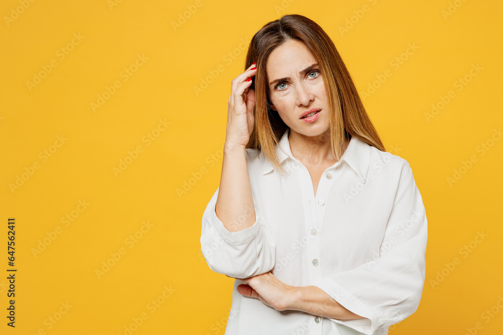 Young sad displeased minded disappointed caucasian woman she wears white shirt casual clothes look camera prop up head forehead isolated on plain yellow background studio portrait. Lifestyle concept. Young sad displeased minded disappointed caucasian woman she wears white shirt casual clothes look camera prop up head forehead isolated on plain yellow background studio portrait. Lifestyle concept.