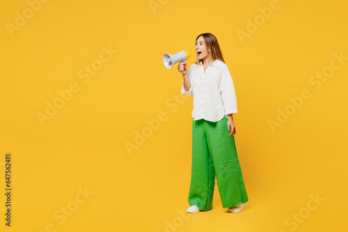 Full body young happy woman she wears white shirt casual clothes hold in hand megaphone scream announces discounts sale Hurry up isolated on plain yellow background studio portrait. Lifestyle concept. © ViDi Studio