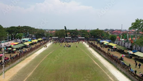 Beautiful drone shot for the Karapan Sapi final held annually on Madura Island at Pamekasan Stadium, Madura, Indonesia photo