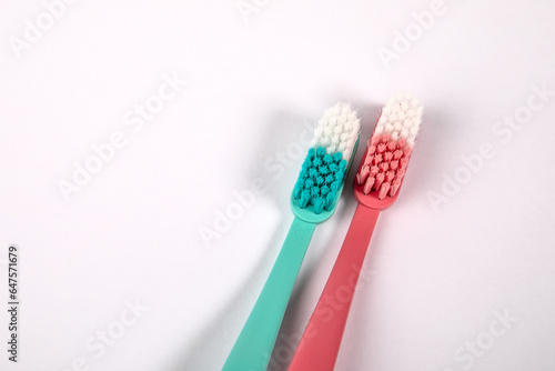 Pink and green toothbrush on a white background. Object  dental hygiene