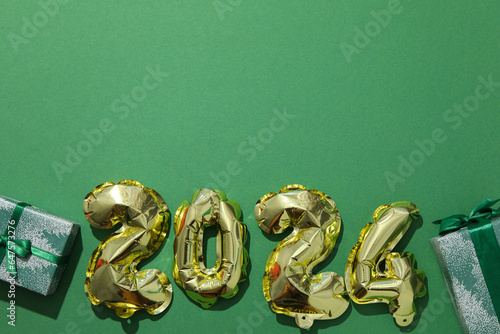 New Year 2024 with golden balloons with gifts
