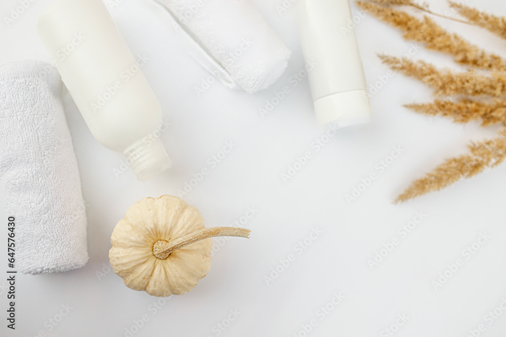 Hair and body care. Packaging for cosmetics and autumn d cor on a white background. Beauty product design, skincare and haircare concept. Hair and body care. Packaging for cosmetics and autumn d cor on a white background. Beauty product design, skincare and haircare concept.