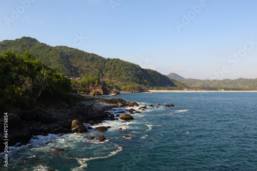 rocky coast with blue water and small wave