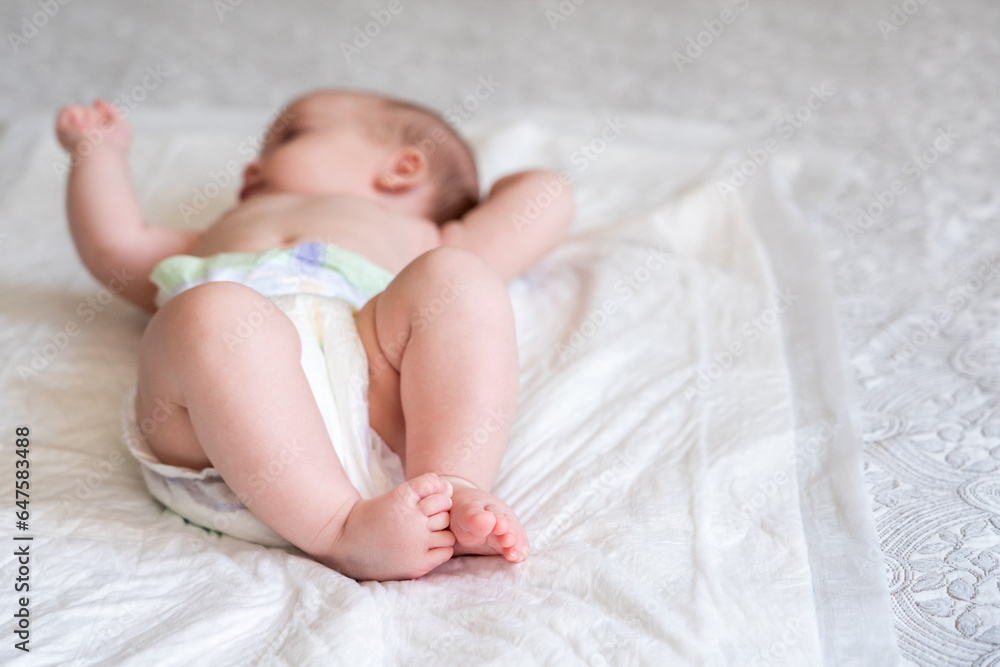 Infant feet stealing the show on soft bedding. Concept of life's gentle introductions Infant feet stealing the show on soft bedding. Concept of life's gentle introductions