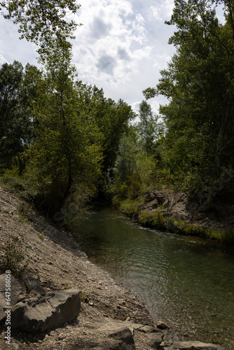 river with watercourse in the valley of mountainous area © Vanesa