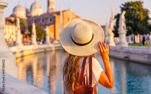 Young woman travel in Italy- Padua, Padova, Padoue city, river and bridge- Prato della Valle square and Santa Giustina basilica