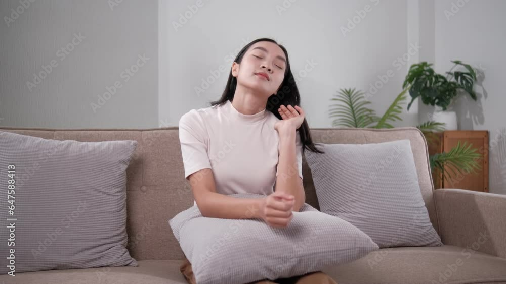 Unhappy young woman touching forehead, yearning, thinking about relationship problems, feeling depressed and lonely, sitting on couch alone, frustrated female suffering from headache or migraine Unhappy young woman touching forehead, yearning, thinking about relationship problems, feeling depressed and lonely, sitting on couch alone, frustrated female suffering from headache or migraine
