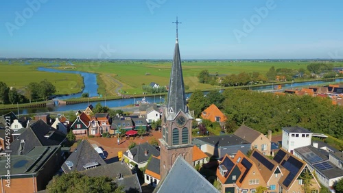 Slow circle pan to left of North Holland old village center next to older and canal photo