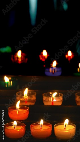 Colorful candles burning in a religious celebration. Frontal view
