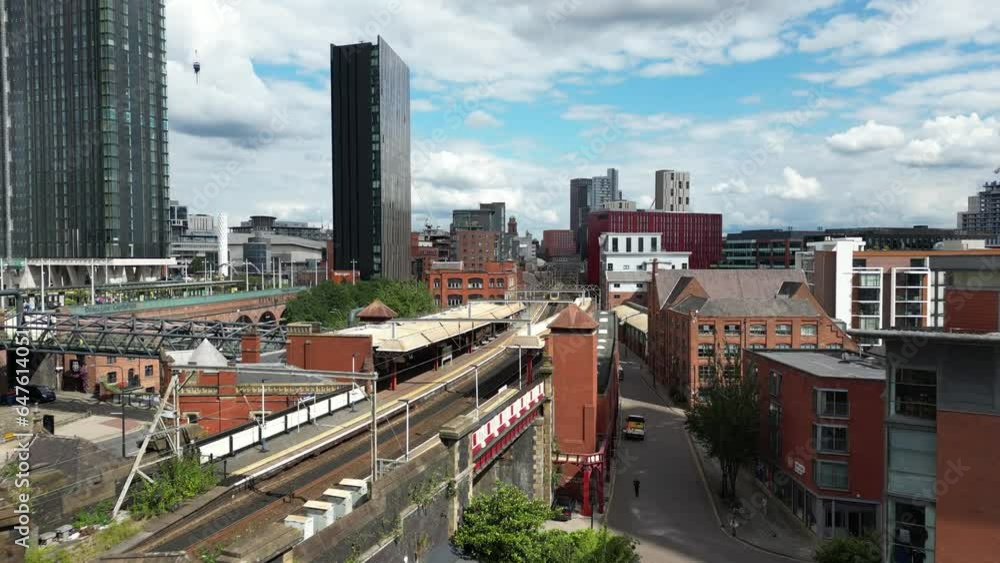 Aerial drone flight passing over Deansgate Train Station and heading over the rooftops towards Oxford Road in Manchester City Centre Aerial drone flight passing over Deansgate Train Station and heading over the rooftops towards Oxford Road in Manchester City Centre