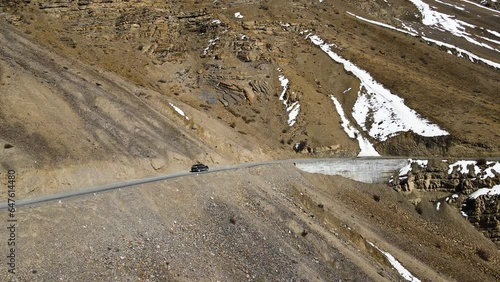 drone flowing a car in spiti valley himachal pradesh driving mountains Himalaya india landscape  photo
