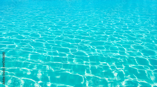 Turquoise bright water surface with sun refection in swimming pool. Relaxation background