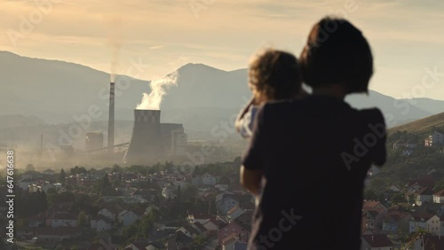 big chimney smoke over the city. Polluted environment. Mother with children watching chimney pollution environment. 