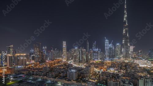 Panorama showing Dubai's business bay towers aerial night timelapse. Rooftop view of some skyscrapers