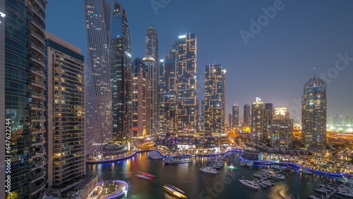 Dubai marina tallest skyscrapers and yachts in harbor aerial day to night timelapse. © neiezhmakov