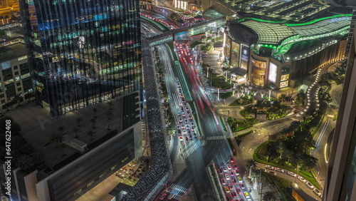 Aerial panorama of Downtown Dubai with shopping mall and traffic on a street day to night timelapse from above, UAE © neiezhmakov