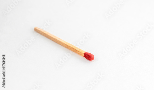 Close up of match isolated on white. Single red match stick.