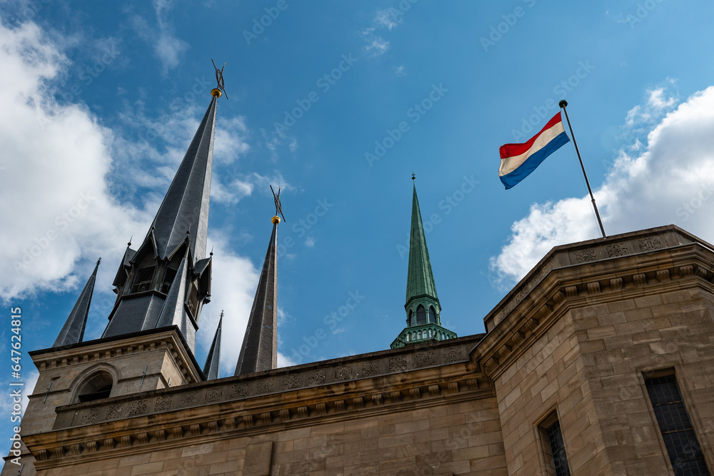 The crypt of the Cathédrale Notre-Dame in Luxembourg. Top of the steeple and the national flag of Luxembourg.
