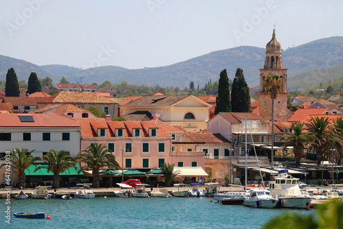 Picturesque small town Vela Luka, on island Korcula, in Croatia. Selective focus, pink oleander flowers in the foreground.