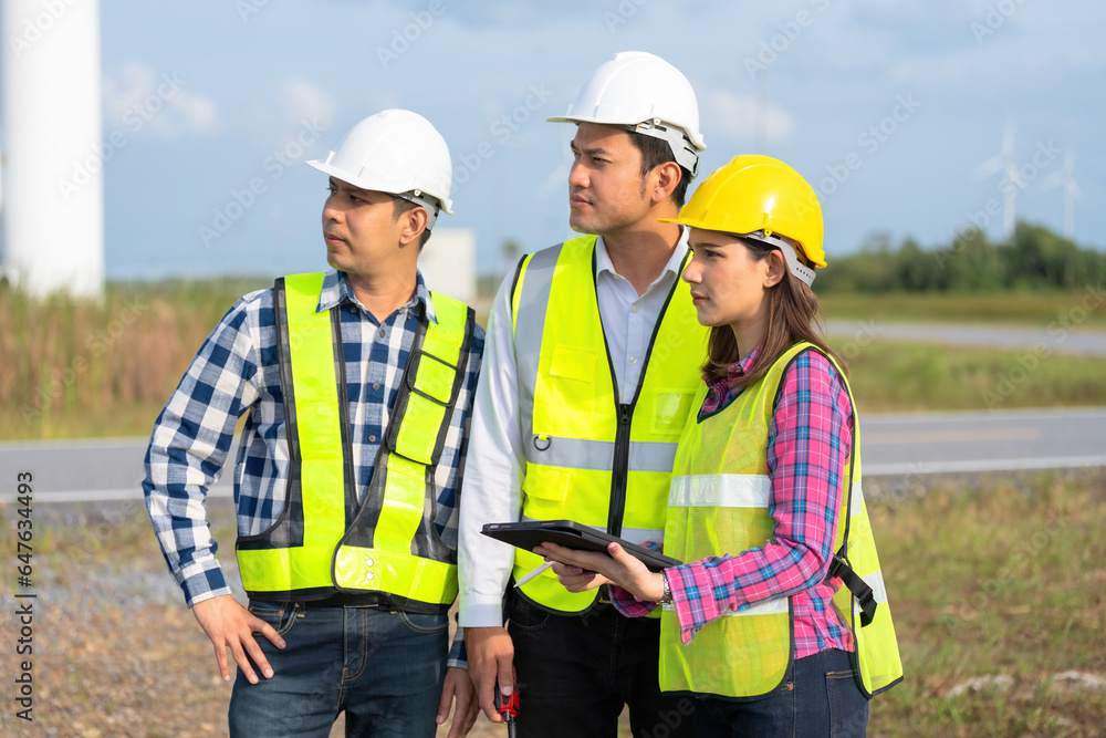 Half-body photograph of a team of 3 male and female engineers. Asian professionals. Wear a safety helmet and vest. looking forward There are radios and tablets for industrial work. Half-body photograph of a team of 3 male and female engineers. Asian professionals. Wear a safety helmet and vest. looking forward There are radios and tablets for industrial work.