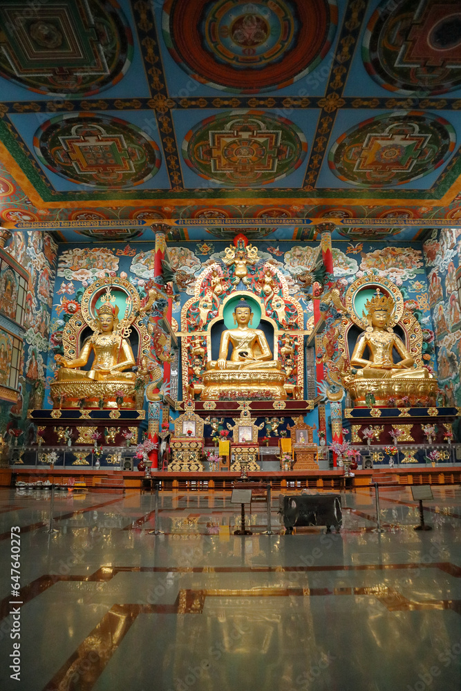 A Portrait picture of the Colorful Interiors of the Buddhist Golden temple dedicated to Avatars of Lord Buddha at the Tibet colony in Bylakuppe in India.