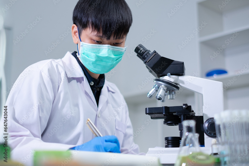 Scientist is recording or study with aloe vera sample in plant laboratory. Concept of medical, herbal skin care, cosmetic, biology, pharmaceutical and biochemistry research. Genetic discovery. Scientist is recording or study with aloe vera sample in plant laboratory. Concept of medical, herbal skin care, cosmetic, biology, pharmaceutical and biochemistry research. Genetic discovery.