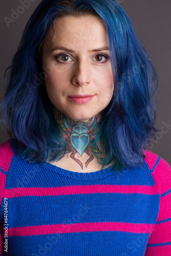 Portrait of the woman with blue hair and a throat tattoo