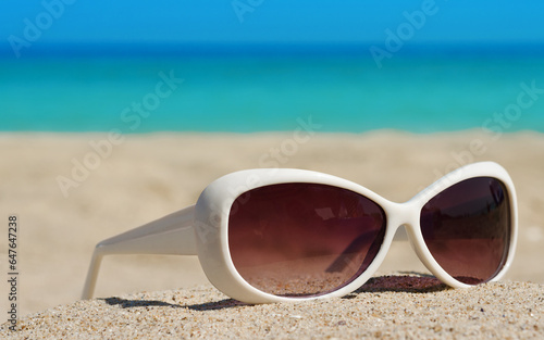  White sunglasses on a sandy beach
