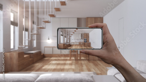 Hand holding smart phone, AR application, simulate furniture and interior design products in real home, architect designer concept, blur background, japandi kitchen and dining room