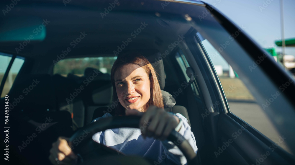 positive beautiful woman driver driving a car on a sunny day, work as a driver, successful career trip