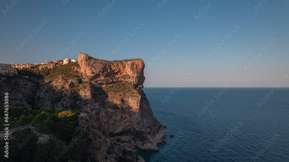 Aerial view of Breathtaking coastal panorama with clear blue sea, rugged cliffs, and serene tranquility , Zona Encinas, Cumbre del Sol, Alicante, Spain. Aerial view of Breathtaking coastal panorama with clear blue sea, rugged cliffs, and serene tranquility , Zona Encinas, Cumbre del Sol, Alicante, Spain.