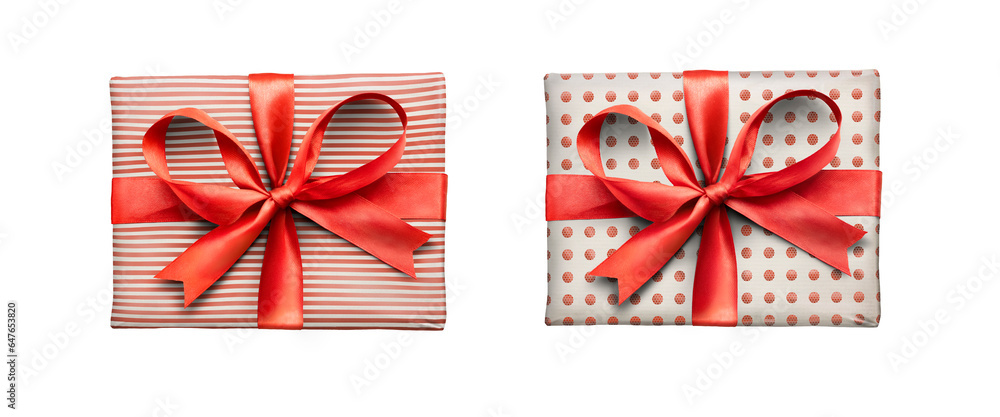 Christmas, birthday or valentine presents decorated in red spots and stripes with a red ribbon bow isolated against a transparent background.