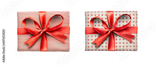 Obraz na płótnie Christmas, birthday or valentine presents decorated in red spots and stripes with a red ribbon bow isolated against a transparent background. w salonie
