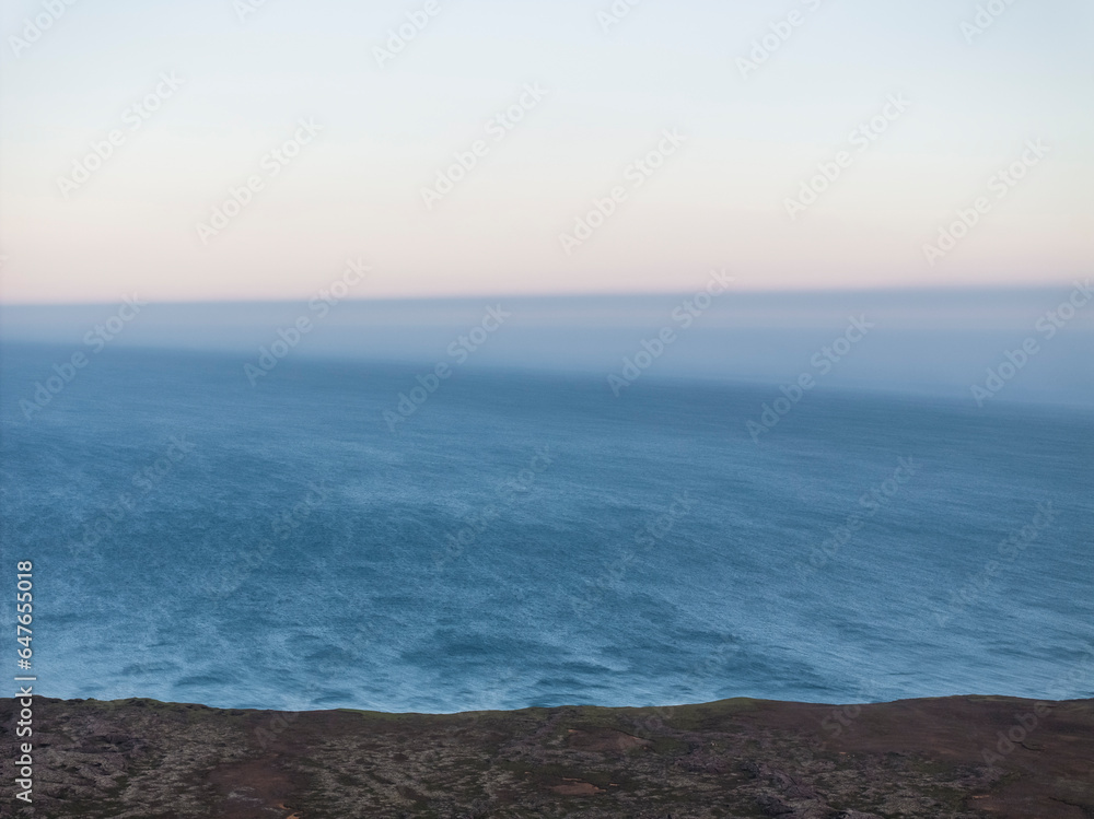Aerial view of the wild coastline along the ocean at sunset, Grindavík, Capital Region, Iceland. Aerial view of the wild coastline along the ocean at sunset, Grindavík, Capital Region, Iceland.