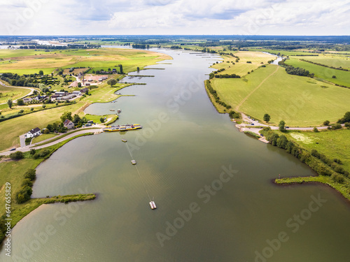 Aerial view of river Nederrijn with groynes and crossing ferry between Eck en Wiel and Amerongen, border between provinces of Gelderland and Utrecht, Netherlands. photo