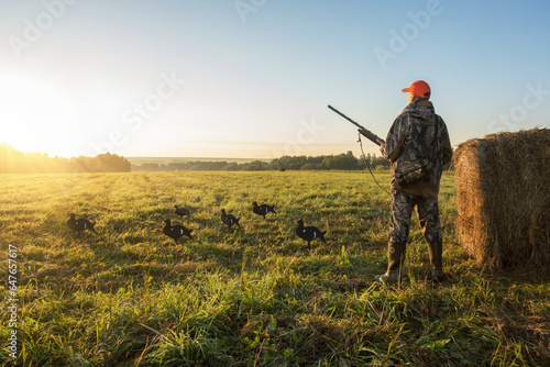  hunter hunting in autumn nature at sunrise. bird hunting.