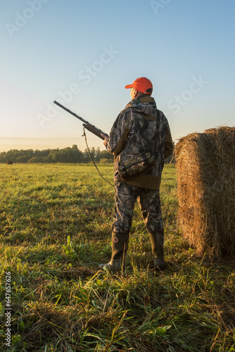Hunter man. Hunting period, autumn season. Male with a gun.