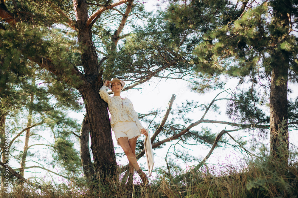 a middle-aged female artist paints a picture in nature a middle-aged female artist paints a picture in nature