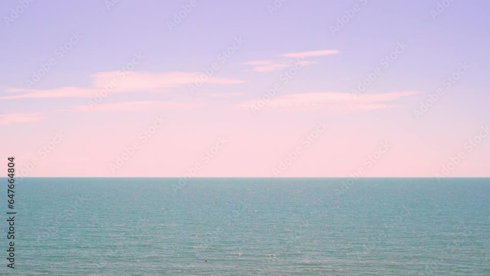 Blue Ocean and Cirrus Soft Pink Clouds in the Lilac Colorful Sky at Dawn Time Lapse. Sea Horizon Beautiful Sunrise Skyscraper with Light Colored Clouds. Beach, Seascape Background Relax Beauty Planet. Blue Ocean and Cirrus Soft Pink Clouds in the Lilac Colorful Sky at Dawn Time Lapse. Sea Horizon Beautiful Sunrise Skyscraper with Light Colored Clouds. Beach, Seascape Background Relax Beauty Planet.