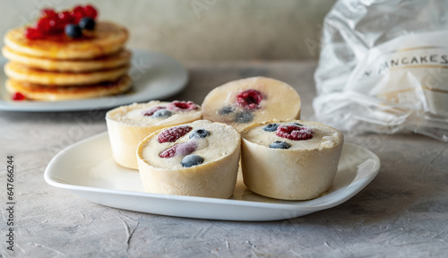Frozen batter with berries for pancakes are homemade preparation or trendy ice cube pancakes
