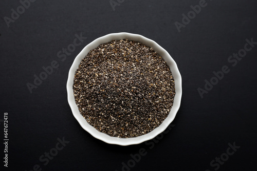 Chia seeds on dark background.