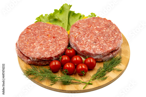Raw hamburger patty isolated on white background. Raw veal hamburger patties with herbs and spices. Close up