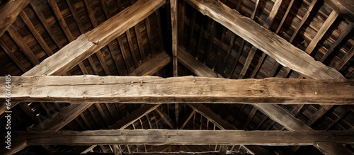 Close up view of old barn roof from below with wooden rafters