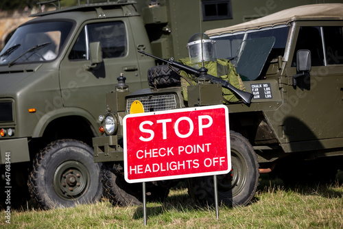 Military checkpoint checkpoint stop sign with gun and body armour no people