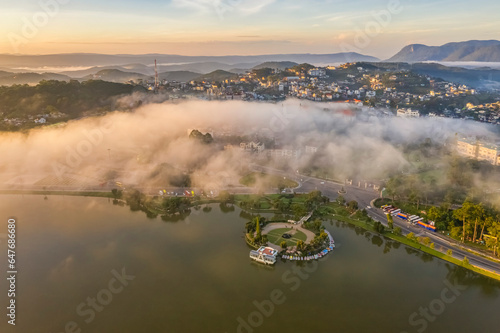 Top view aerial photo from flying drone of a Da Lat City with development buildings, transportation, nature beautifull, famoust travel city of Vietnam. photo